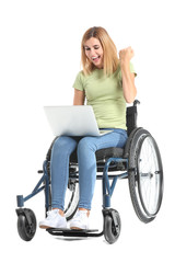 Happy woman with laptop in wheelchair on white background
