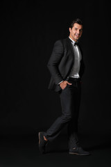 Fashionable man in formal clothes on dark background