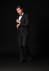 Fashionable man in formal clothes on dark background