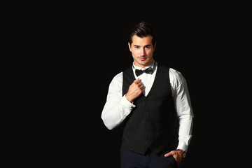 Stylish fashionable man on dark background