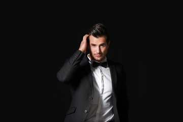 Fashionable man in formal clothes on dark background