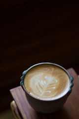 Hot latta art on wooden