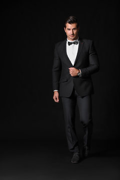 Fashionable man in formal clothes on dark background