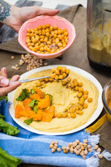 Original homemade arabic chickpea hummus with olive oil and cumin. Creamy dip paste.