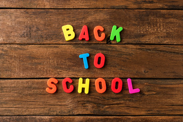 Back to school. Text on vintage wooden background. Top view