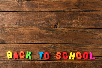 Back to school. Text on retro wooden background with copyspace