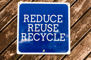 Handwriting text writing Reduce Reuse Recycle. Conceptual photo environmentallyresponsible consumer behavior Empty blue board with copy space above wooden background
