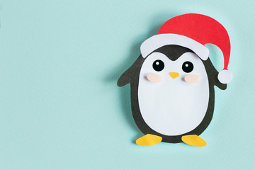 Christmas penguin from paper on a blue background