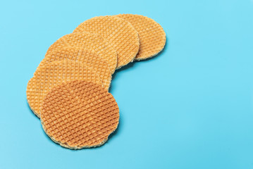 Sweet round waffles on blue