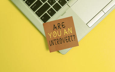 Writing note showing Are You An Introvertquestion. Business concept for demonstrating who tends to turn inward mentally Metallic trendy laptop blank sticky note empty text colored background
