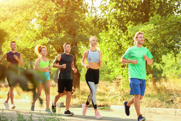 Group of sporty young people running outdoors