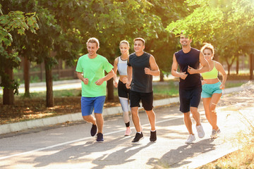 Group of sporty young people running outdoors