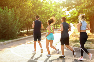 Group of sporty young people running outdoors