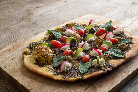 lebanese Manoushe ,bread of thyme topped with mint, reddish, and Labneh; Lebanese Zaatar Manouche; zaatar flat bread