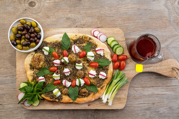 lebanese Manoushe ,bread of thyme topped with mint, reddish, and Labneh; Lebanese Zaatar Manouche;...