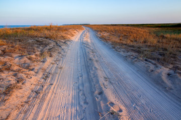 Sandy road over the sea at sunset. Durankulak, Northern Black Sea Coast, Bulgaria.