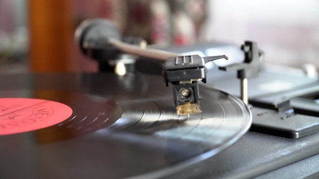 Retro vinyl player. Vinyl record player. Needle on vinyl record. Record player. Vintage Vinyl Record Player Is Spinning. The rotating plate and stylus with the needle close-up. 
