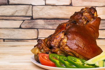 Baked pork shank with crispy caramelized crust with vegetables. Space for text