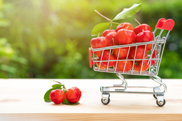 Acerola cherry in cart on wooden background. Select  focus, Barbados cherry, Malpighia emarginata, high vitamin . Acerola fruit.