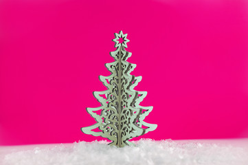 Wooden Christmas tree with artificial snow tree on pink background with copy space. Christmas tree, minimal New Year s card. Holidays, Congratulation concept. Place for text, flat lay.