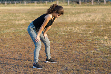 A young slim athletic girl in sportswear with snakeskin prints performs a set of exercises. Fitness...