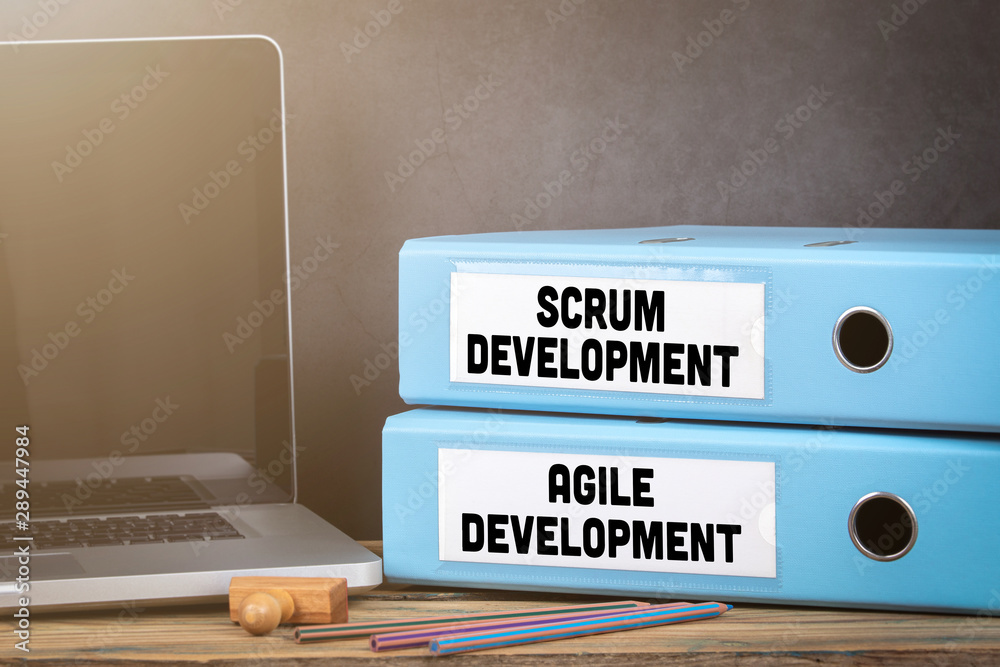 Sticker scrum and agile development. binders on desk in the office