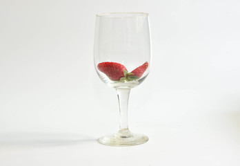 Strawberry in wine glass on white background