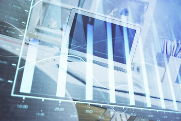 Fototapeta premium Forex Chart hologram on table with computer background. Multi exposure. Concept of financial markets.
