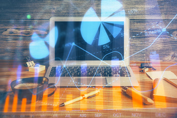 Multi exposure of chart and financial info and work space with computer background. Concept of...