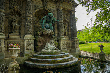 Fototapeta na wymiar The Medici Fountain, fontaine Medicis, is a monumental fountain in the Jardin du Luxembourg in the 6th arrondissement in Paris