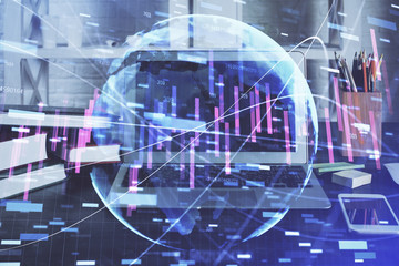 Double exposure of chart and financial info and work space with computer background. Concept of international online trading.