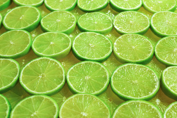 Fresh lime slices as a background.