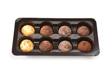 Chocolate candy collection in plastic box.