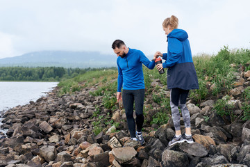 Sportsmen couple hiking outdoor on gloomy day