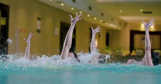 Water team sports, female swimmers performing, synchronized swimming.