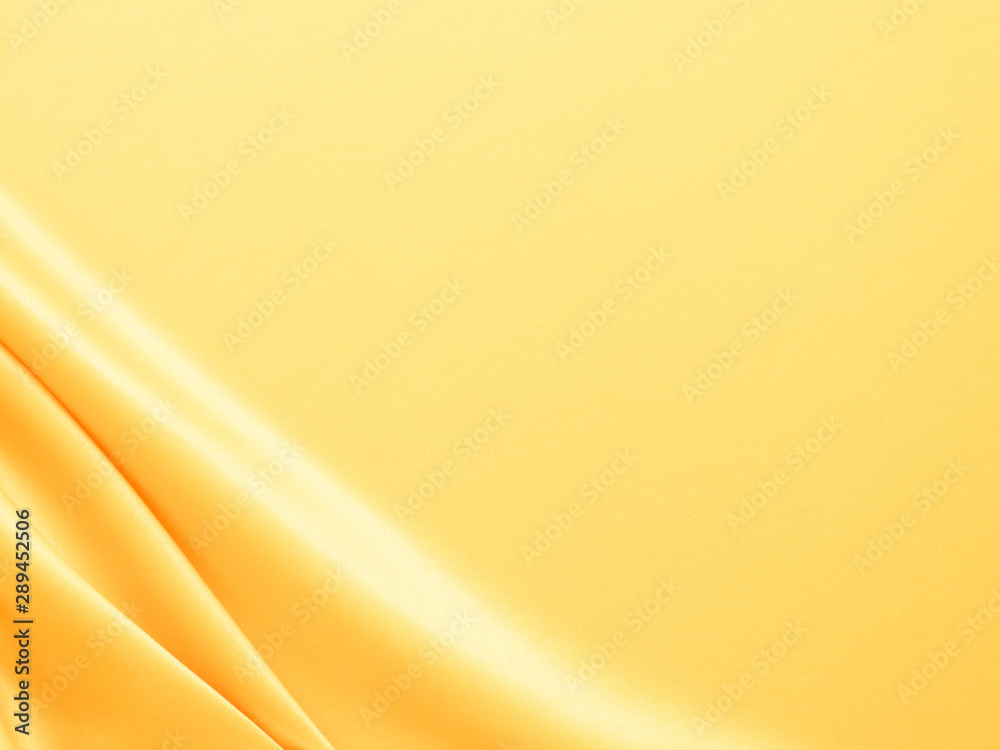 Wall mural beautiful smooth elegant wavy light yellow satin silk luxury cloth fabric texture, abstract backgrou