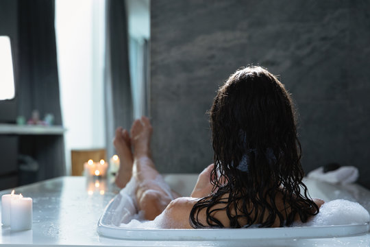 Young brunette woman in a bath
