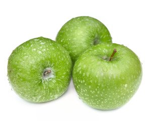 close on three beautiful and freshness green apples covered with water drops