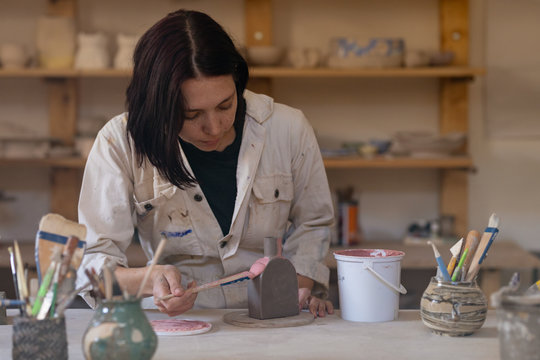 Female potter at work in a pottery studio 