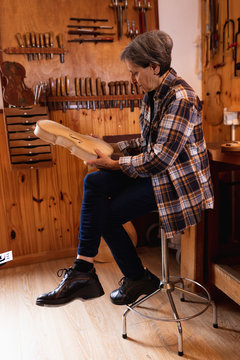 Female luthier at work in a workshop