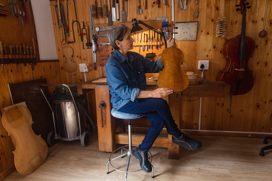 Female luthier at work in a workshop