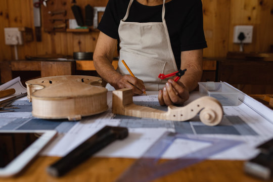 Female luthier at work in a workshop