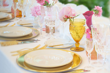 Elegant dinner table set with silverware, napkin and glass at restaurant before party