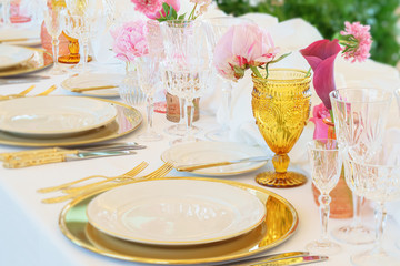 Elegant dinner table set with silverware, napkin and glass at restaurant before party