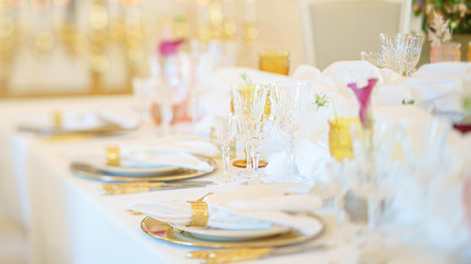 Elegant dinner table set with silverware, napkin and glass at restaurant before party