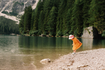 little girl on the shore of a beautiful lake