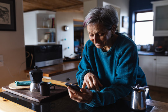 Senior woman using smartphone at home