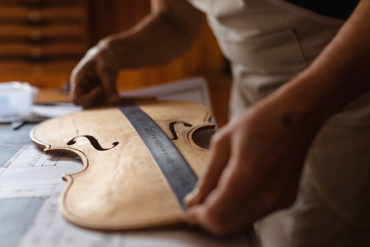 Female luthier at work in a workshop