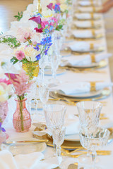 Elegant dinner table set with silverware, napkin and glass at restaurant before party