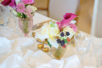 Elegant dinner table set with flowers and berries
